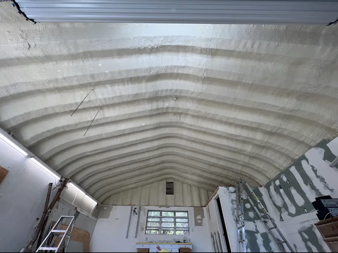 Spray polyurethane foam applied to the underside of a metal roof deck in Merritt Island